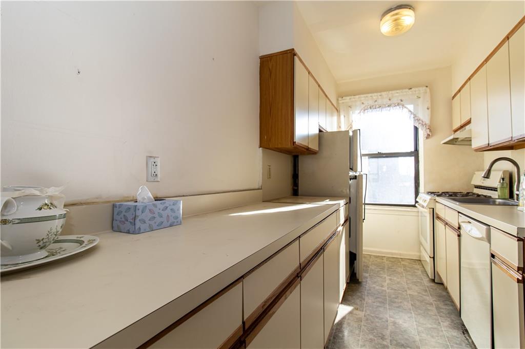 359 Ovington Avenue, Unit D2 Brooklyn, NY 11209 - Photo 13 of 25 a kitchen with a sink appliances and cabinets