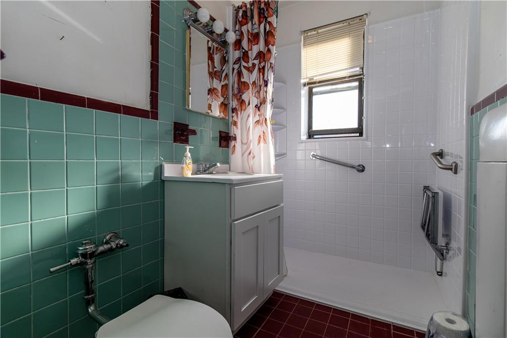 359 Ovington Avenue, Unit D2 Brooklyn, NY 11209 - Photo 16 of 25 a bathroom with a sink toilet and shower