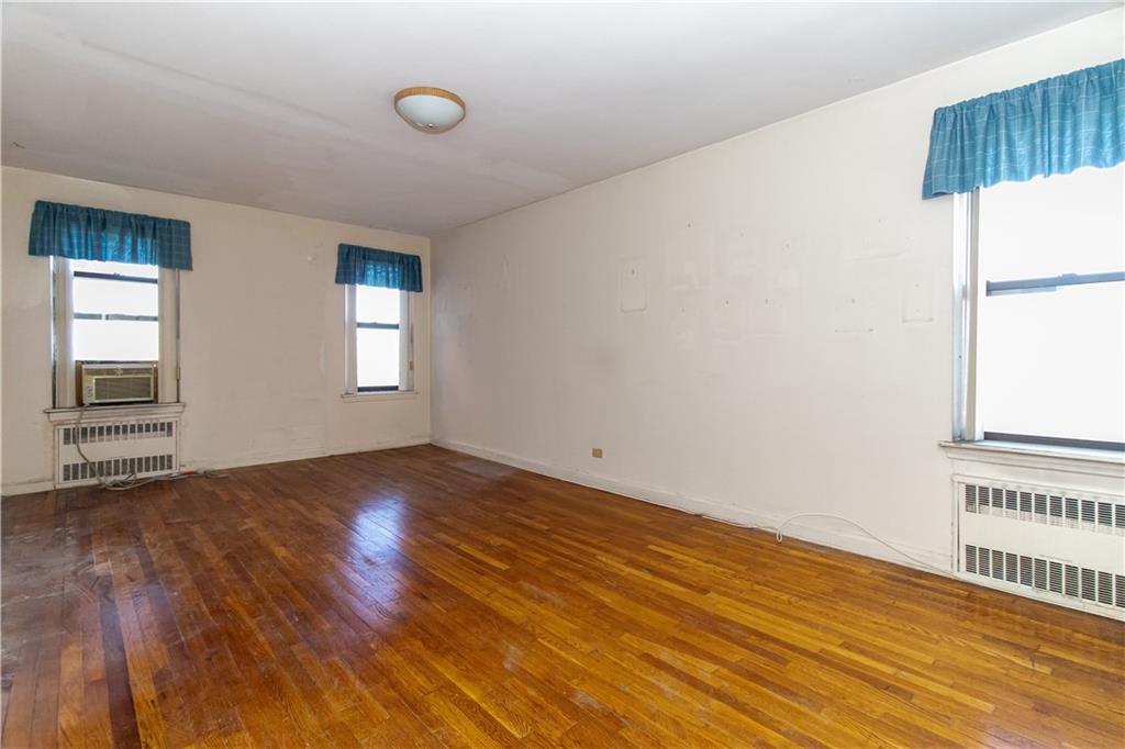 359 Ovington Avenue, Unit D2 Brooklyn, NY 11209 - Photo 17 of 25 an empty room with wooden floor and windows