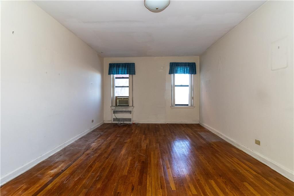 359 Ovington Avenue, Unit D2 Brooklyn, NY 11209 - Photo 18 of 25 an empty room with wooden floor and windows
