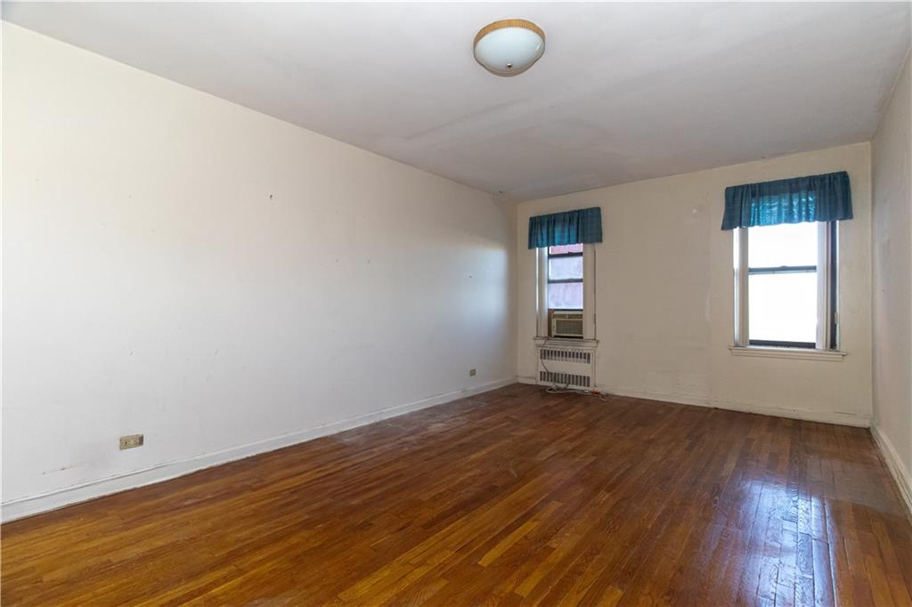 359 Ovington Avenue, Unit D2 Brooklyn, NY 11209 - Photo 19 of 25 an empty room with wooden floor and windows