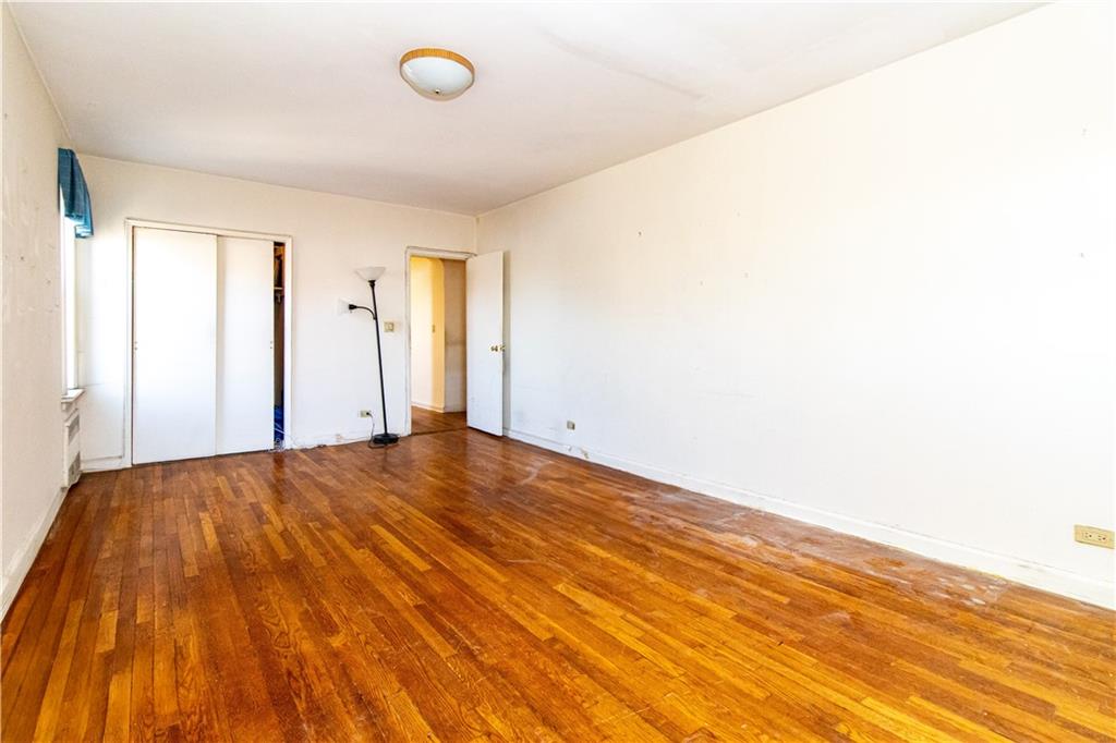 359 Ovington Avenue, Unit D2 Brooklyn, NY 11209 - Photo 20 of 25 an empty room with wooden floor and windows