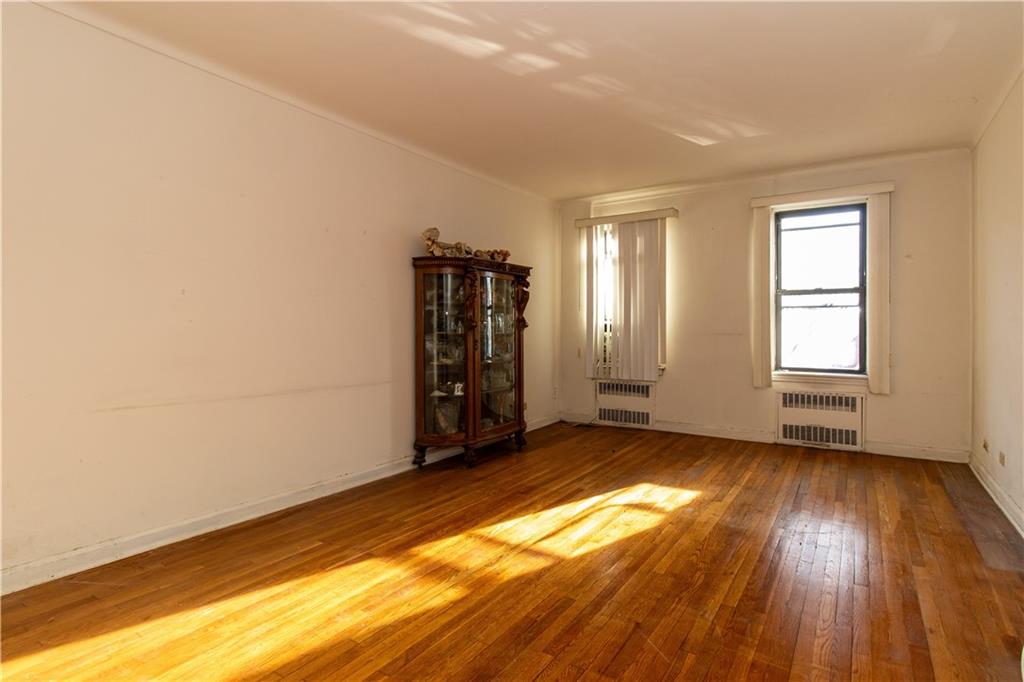 359 Ovington Avenue, Unit D2 Brooklyn, NY 11209 - Photo 6 of 25 an empty room with wooden floor and windows