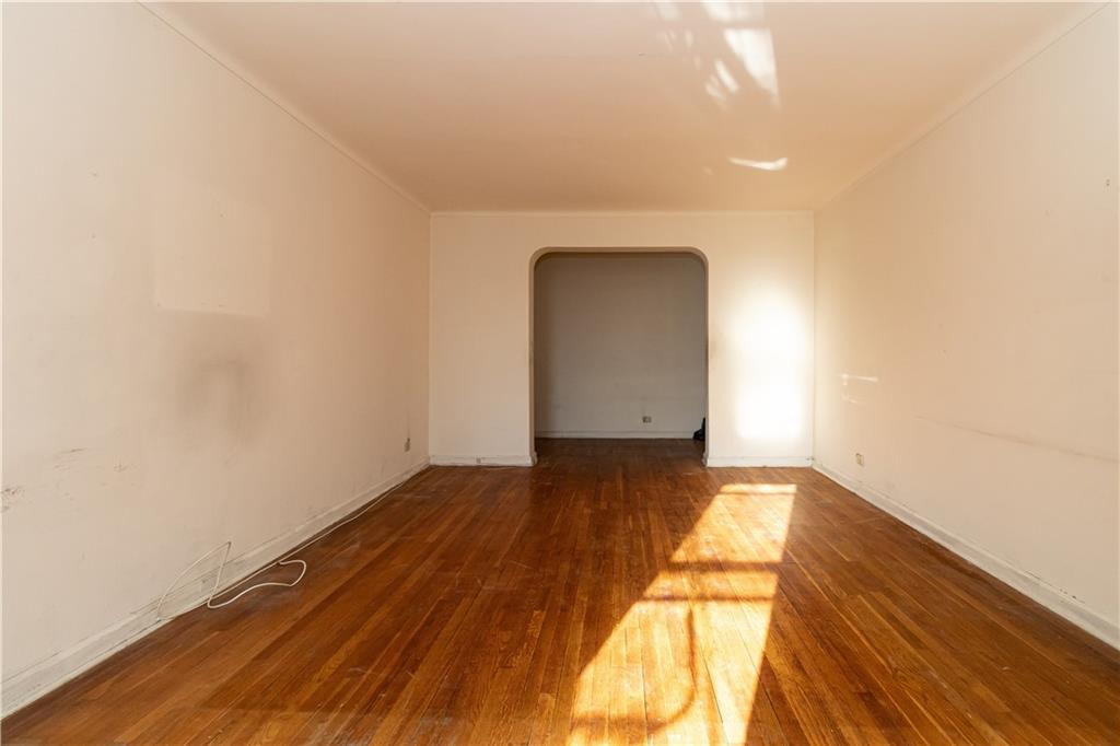 359 Ovington Avenue, Unit D2 Brooklyn, NY 11209 - Photo 9 of 25 a view of empty room with wooden floor and fan