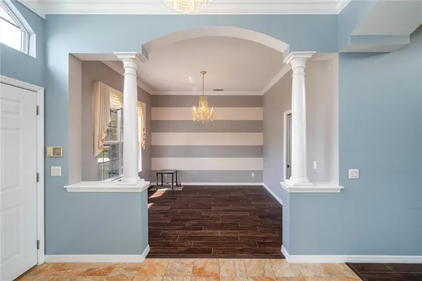 a view of empty room with wooden floor and window