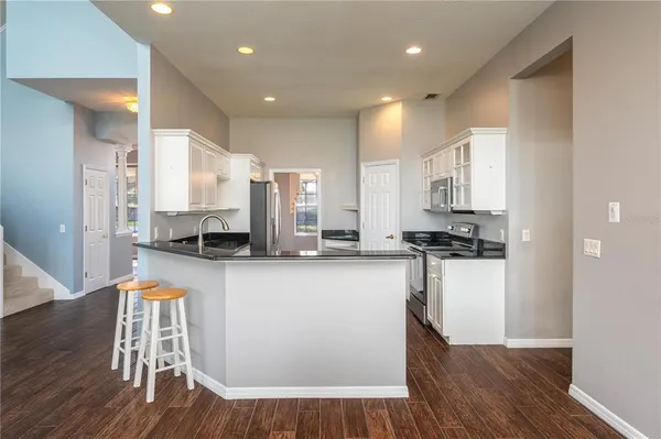 a kitchen with stainless steel appliances granite countertop a stove and a microwave