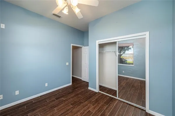 a bathroom with a granite countertop toilet a sink and a mirror