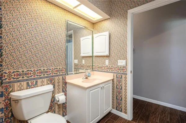 an empty room with closet and a chandelier fan