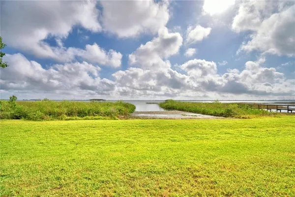 an aerial view of a house with a yard basket ball court and outdoor seating