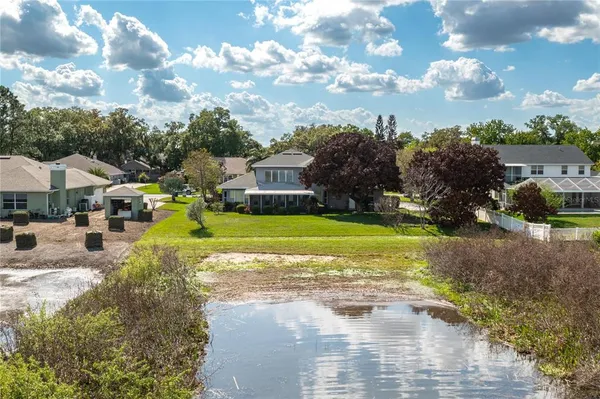 a view of yard with swimming pool and green space