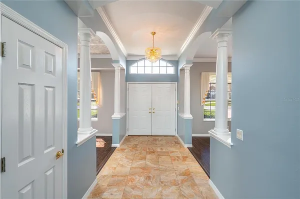 a view of entryway with wooden floor and a front door