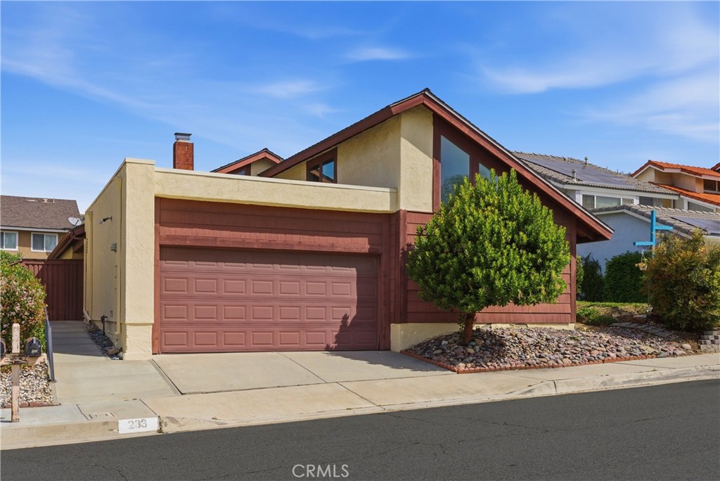 233 Brookshire Place Brea, CA 92821 - Photo 1 of 46 a front view of a house with a yard and garage