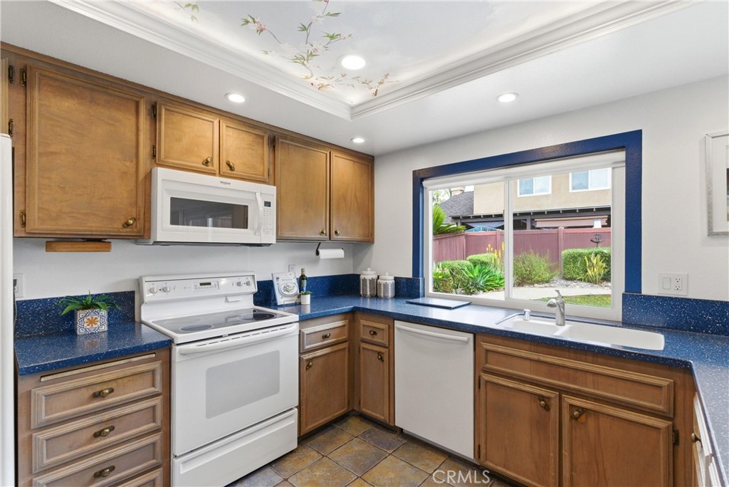 233 Brookshire Place Brea, CA 92821 - Photo 17 of 46 a kitchen with a sink window and cabinets