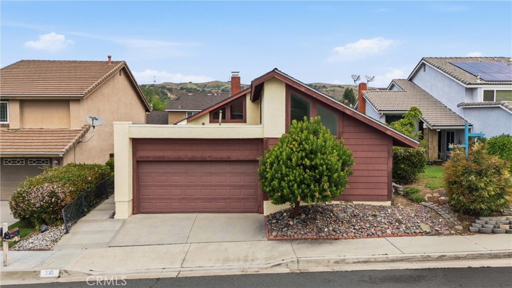 233 Brookshire Place Brea, CA 92821 - Photo 40 of 46 a front view of a house with a yard and garage