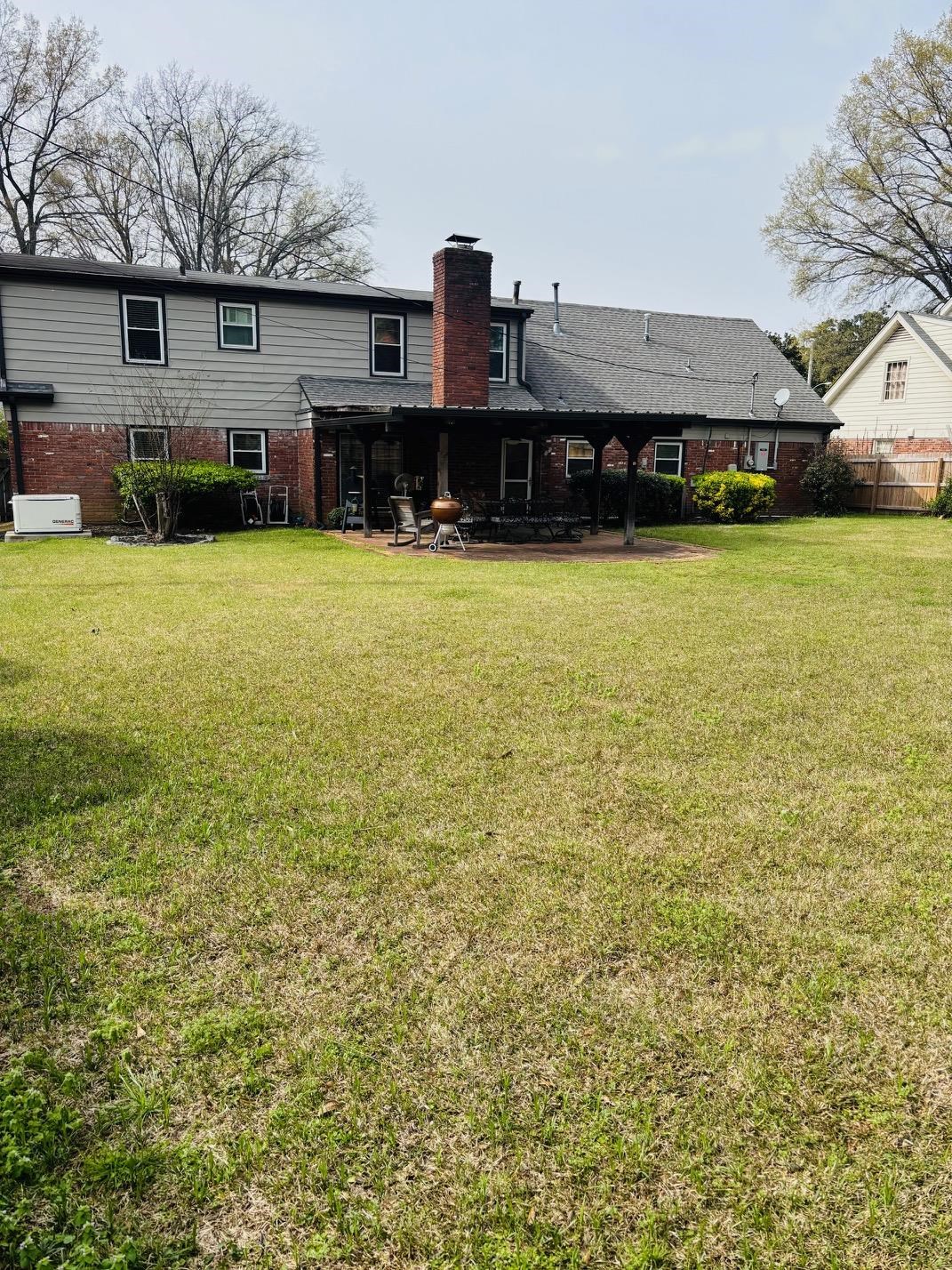 2076 Riverdale Road Germantown, TN 38138 - Photo 20 of 21 Rear view of property with brick siding, a chimney, and a patio