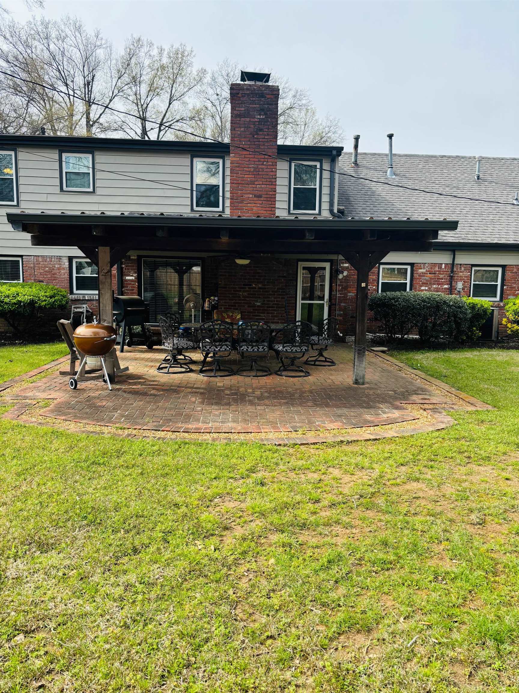 2076 Riverdale Road Germantown, TN 38138 - Photo 21 of 21 Rear view of property featuring a yard, brick siding, a patio, and a chimney