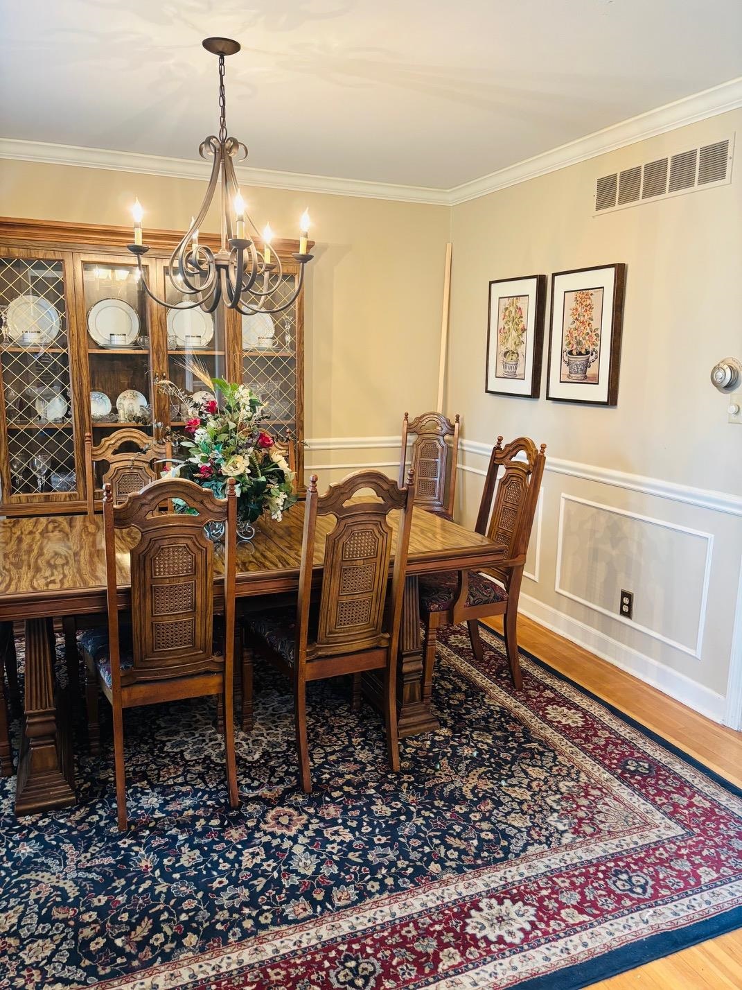 2076 Riverdale Road Germantown, TN 38138 - Photo 3 of 21 Dining area with ornamental molding, hanging lights, light wood-style flooring, a wainscoted wall, and a decorative wall