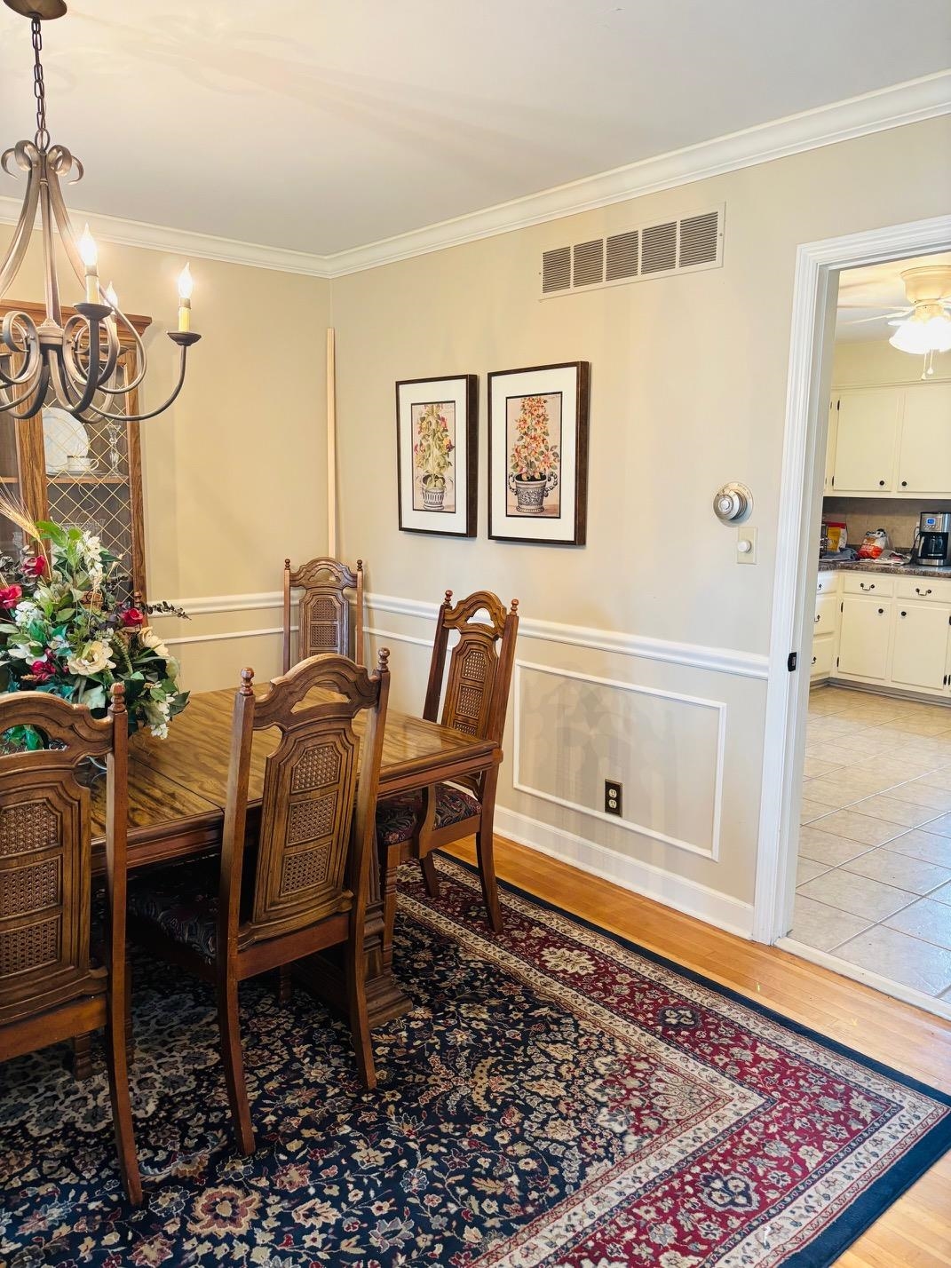 2076 Riverdale Road Germantown, TN 38138 - Photo 4 of 21 Dining room with ornamental molding, light wood-style flooring, hanging lights, a wainscoted wall, and a decorative wall