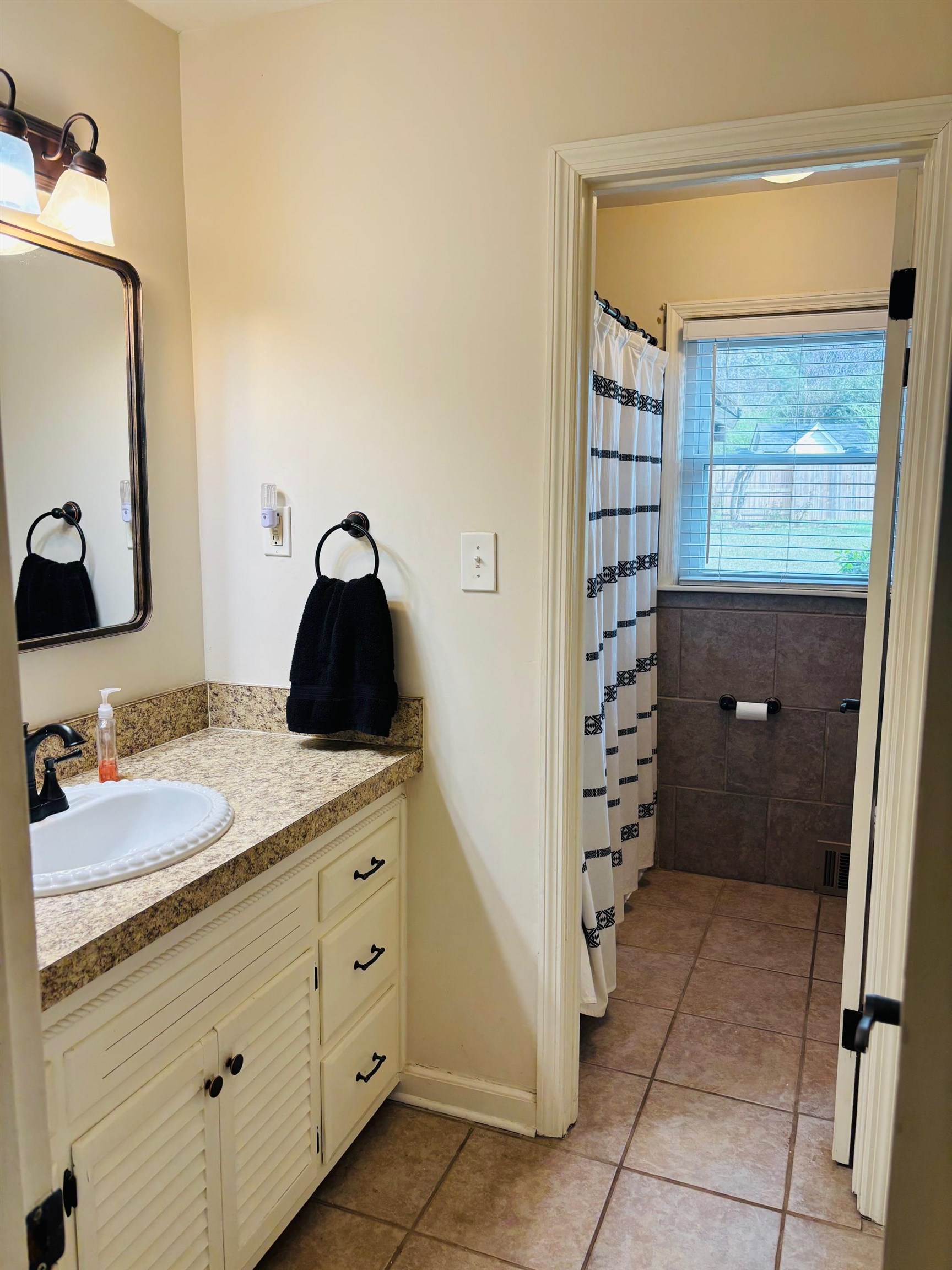 2076 Riverdale Road Germantown, TN 38138 - Photo 10 of 21 Bathroom featuring vanity, a shower with shower curtain, and light tile patterned floors