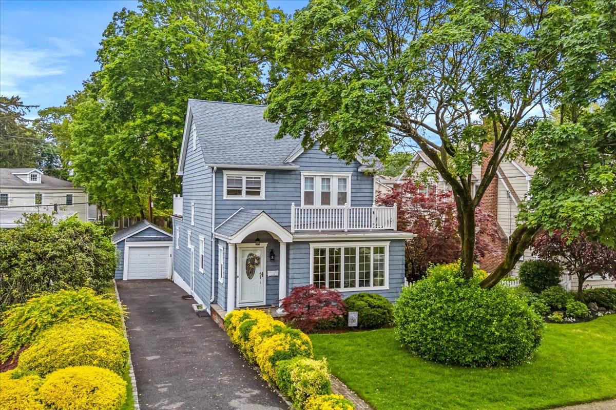 23 Beechwood Avenue Manhasset, NY 11030 - Photo 1 of 40 a front view of a house with a yard