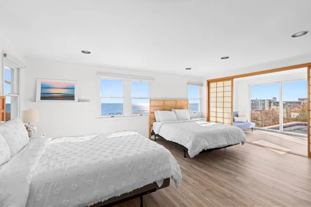 a bedroom with two beds and a large window