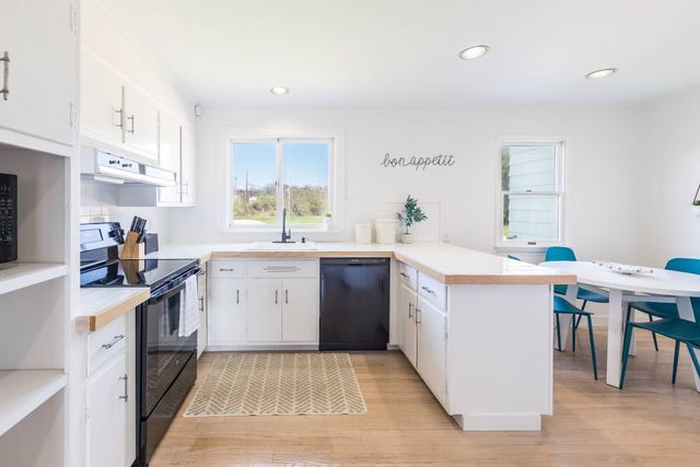 a kitchen with a sink stove and cabinets