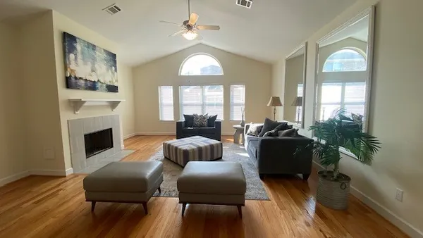 a living room with furniture and wooden floor