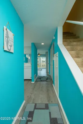 a kitchen with cabinets and a refrigerator