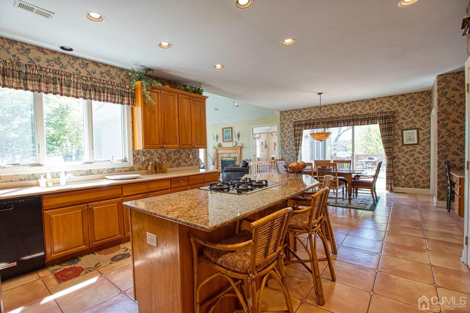 17 Grovers Mill Road Plainsboro, NJ 08536 - Photo 26 of 69 a view of a kitchen with granite countertop a stove a sink a dining table and chairs