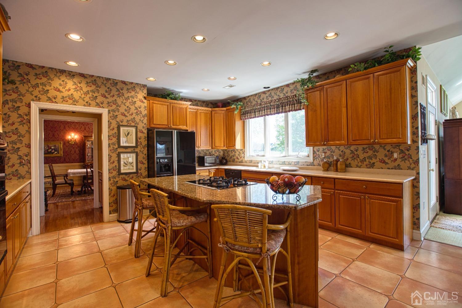 17 Grovers Mill Road Plainsboro, NJ 08536 - Photo 27 of 69 a kitchen with stainless steel appliances granite countertop table chairs sink and window