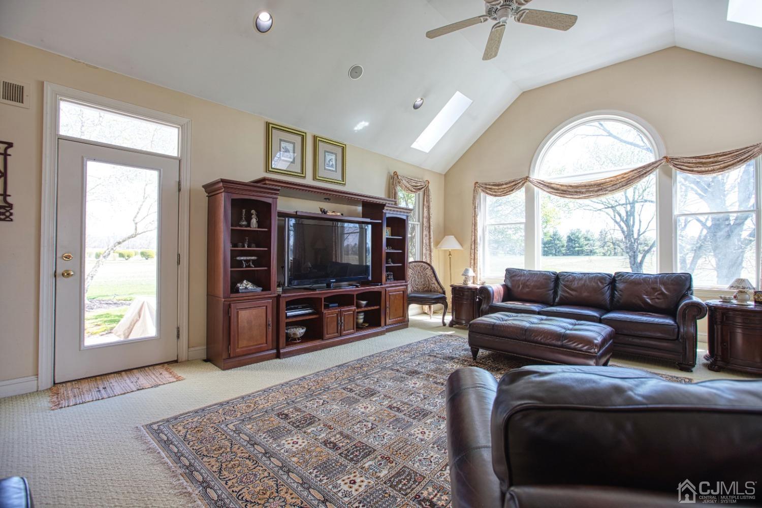 17 Grovers Mill Road Plainsboro, NJ 08536 - Photo 32 of 69 a living room with furniture and a flat screen tv