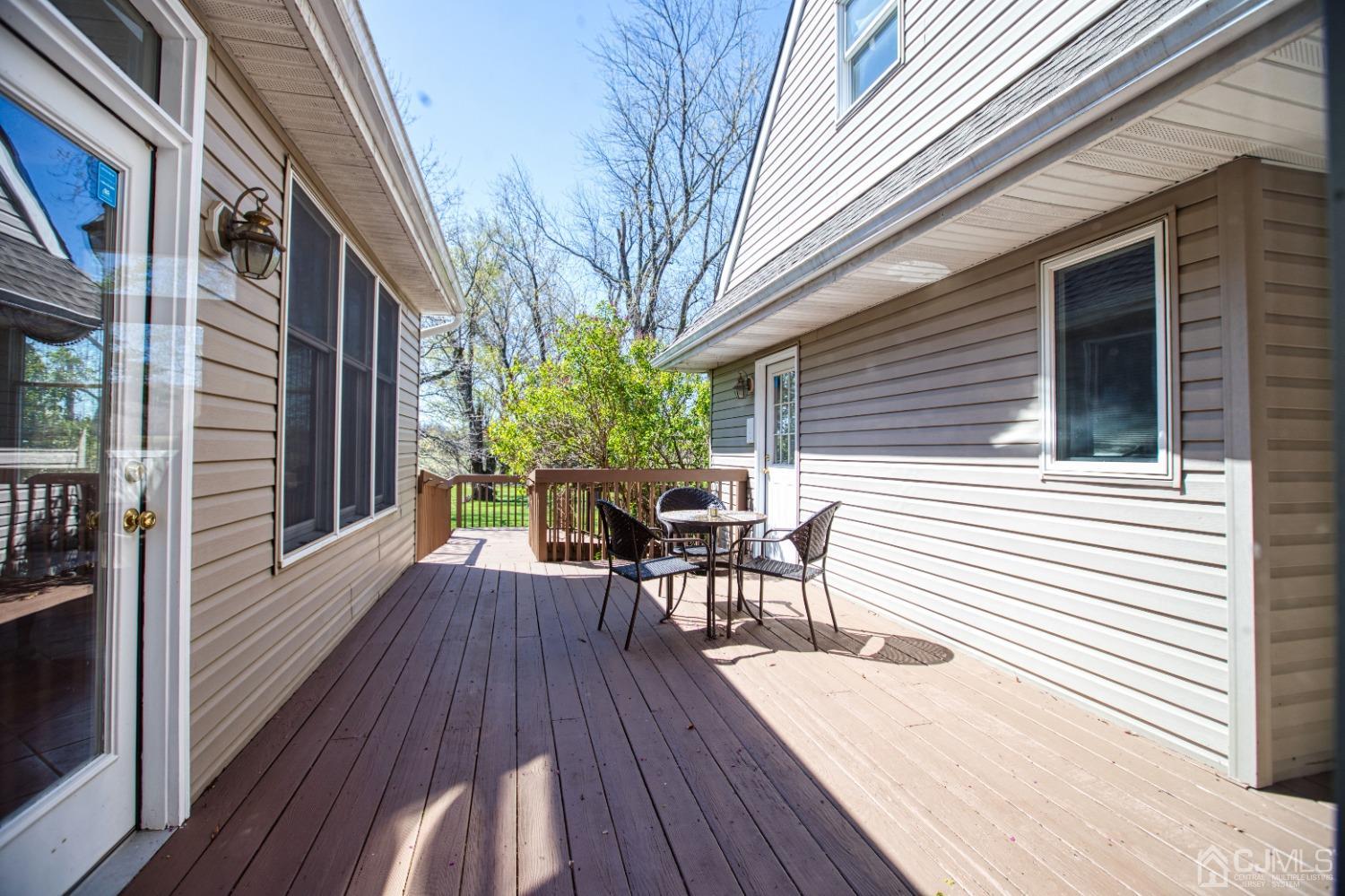 17 Grovers Mill Road Plainsboro, NJ 08536 - Photo 37 of 69 a view of a roof deck with table and chairs and wooden floor