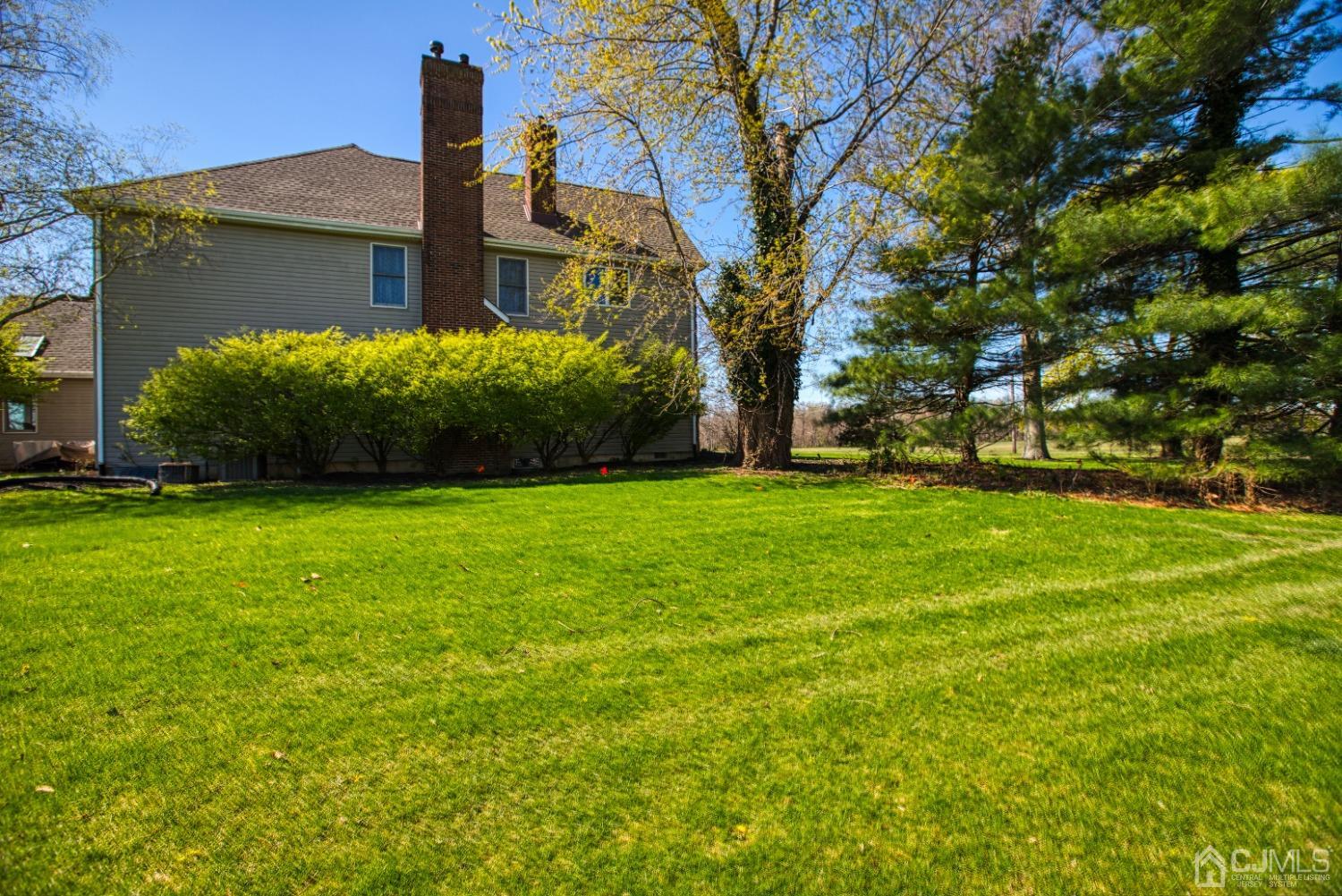17 Grovers Mill Road Plainsboro, NJ 08536 - Photo 5 of 69 a view of a house with a big yard and large trees
