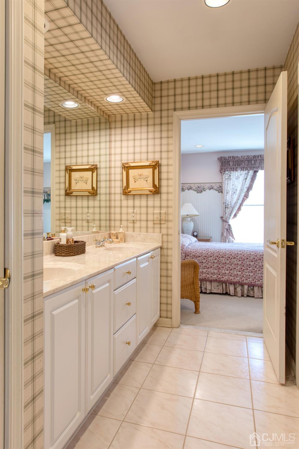 17 Grovers Mill Road Plainsboro, NJ 08536 - Photo 57 of 69 a bathroom with a sink a mirror and a shower