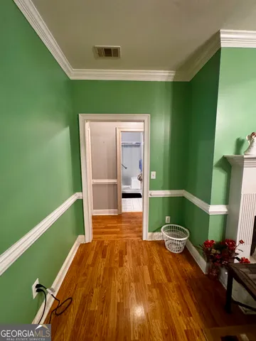 a bedroom with a bed and a wooden floor