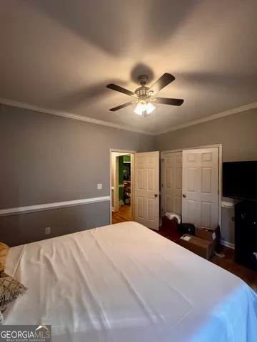 a bedroom with a large bed and a chandelier