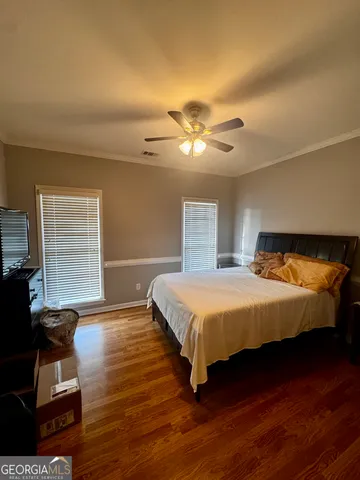 a spacious bedroom with a bed and a window