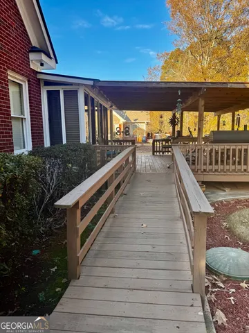 a view of balcony with floor to ceiling windows and wooden floor