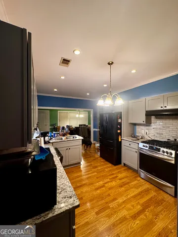 a large kitchen with a large counter top appliances and cabinets