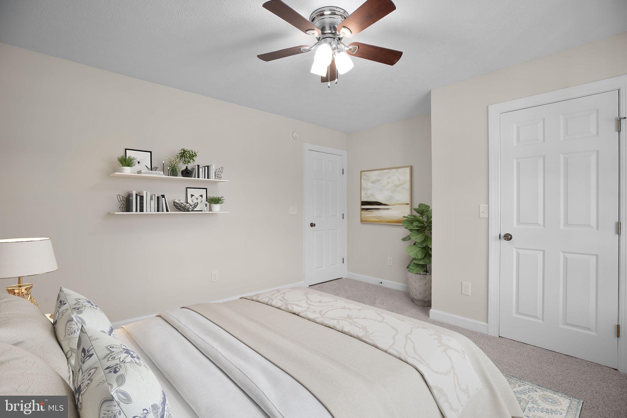 33 Austin Way Bumpass, VA 23024 - Photo 12 of 55 a bedroom with a bed and a chandelier