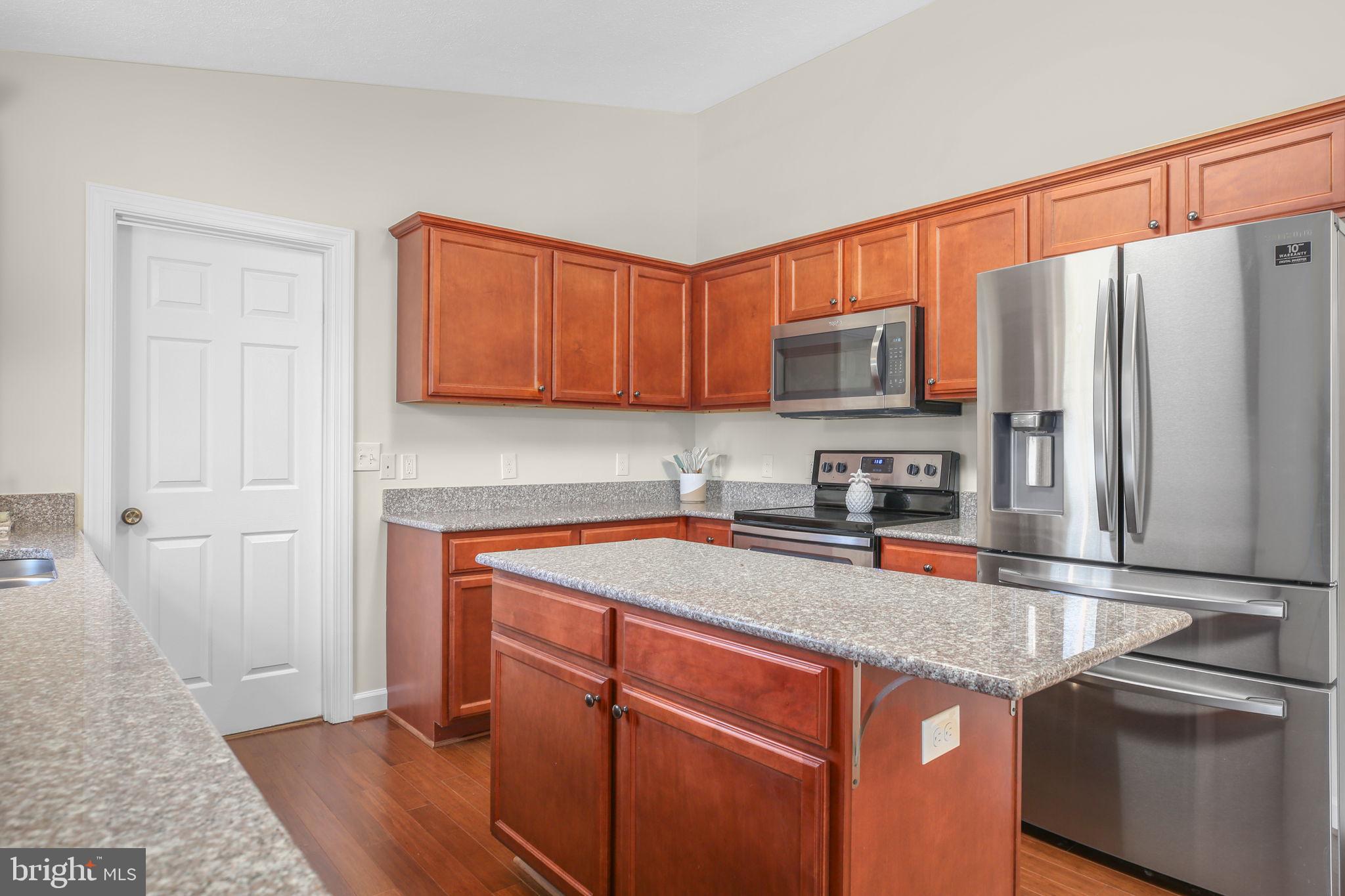 33 Austin Way Bumpass, VA 23024 - Photo 42 of 55 a kitchen with stainless steel appliances granite countertop a refrigerator stove and sink