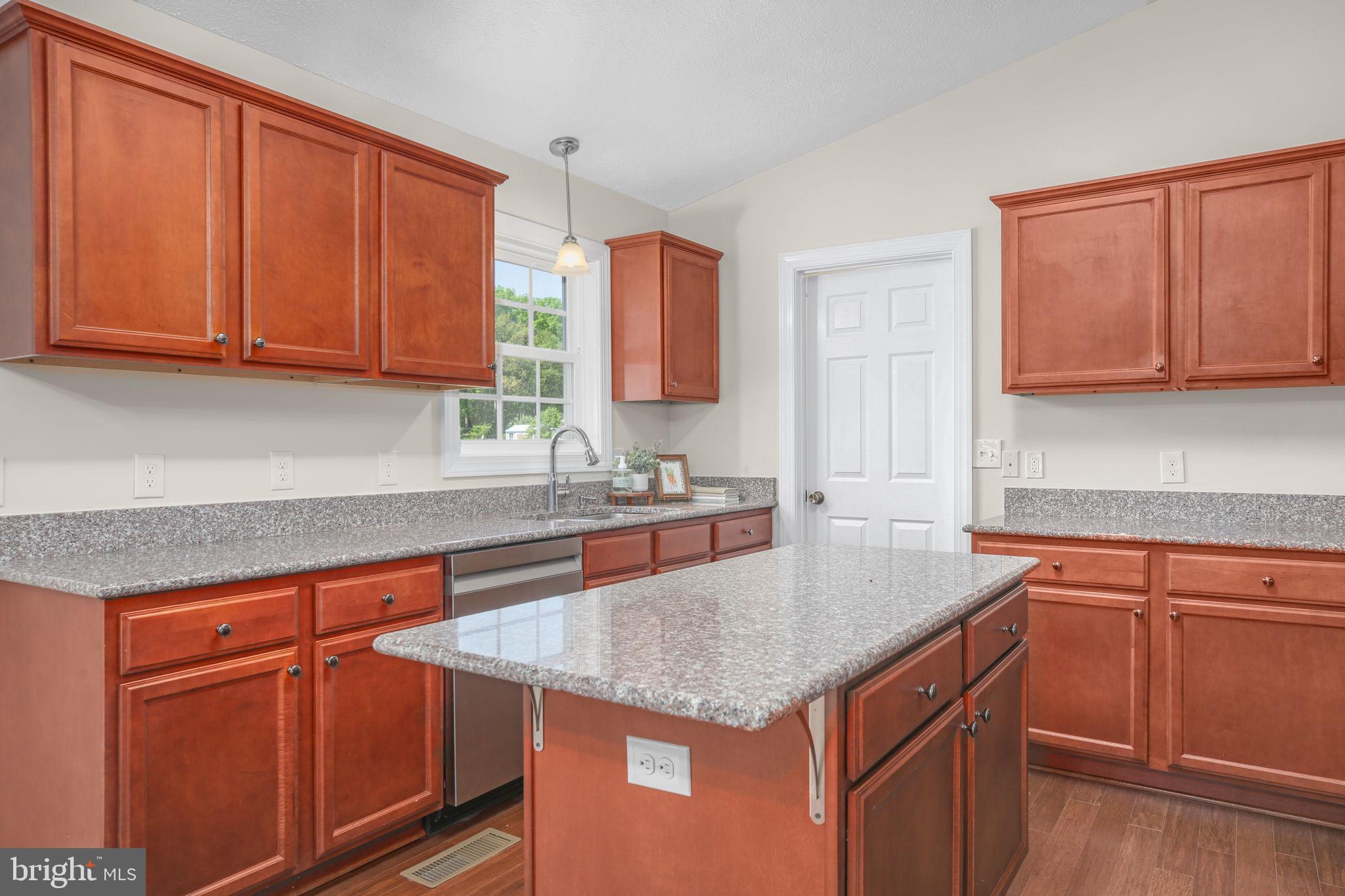 33 Austin Way Bumpass, VA 23024 - Photo 43 of 55 a kitchen with granite countertop a sink dishwasher stove and cabinets with wooden floor