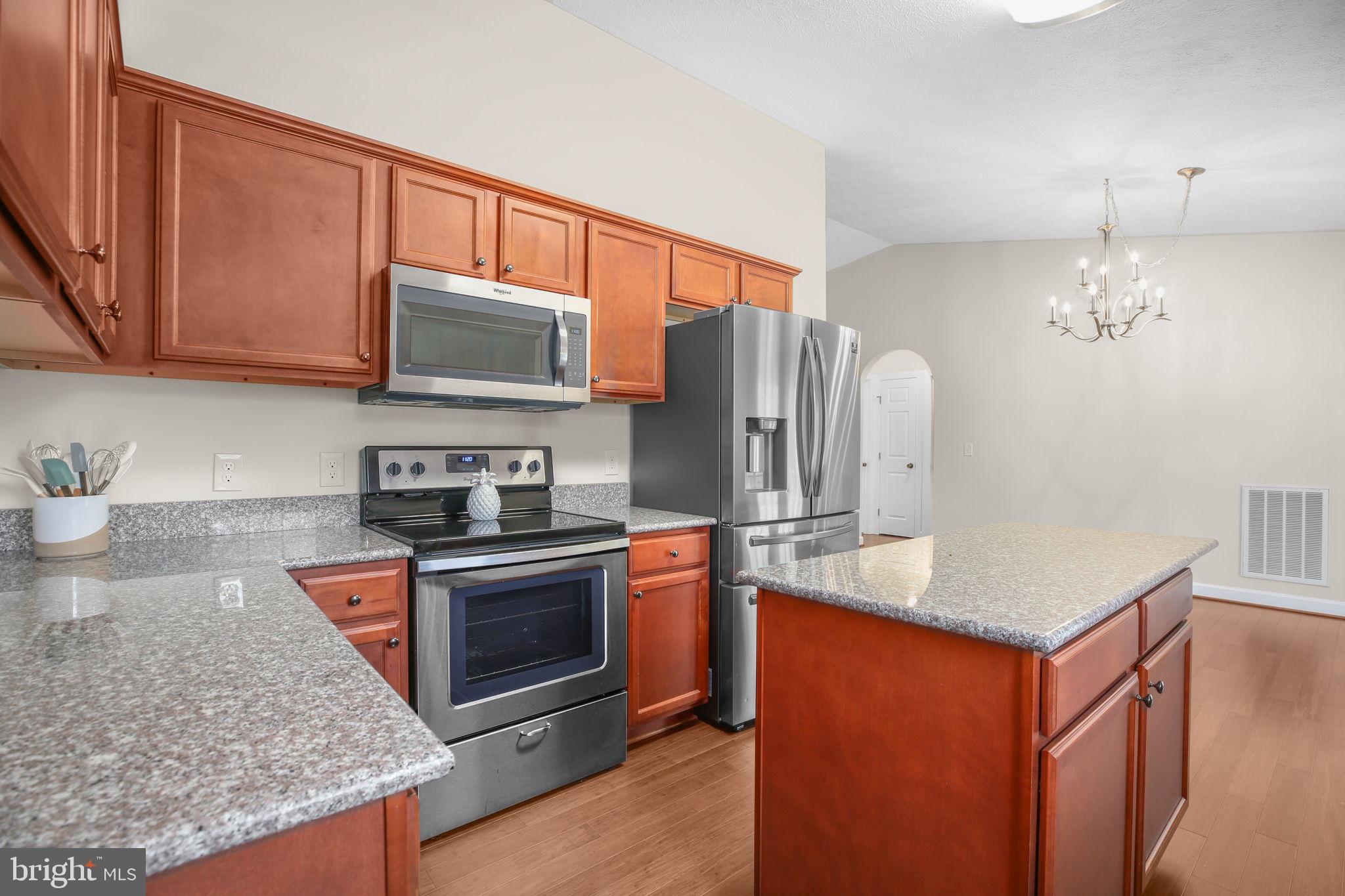 33 Austin Way Bumpass, VA 23024 - Photo 45 of 55 a kitchen with stainless steel appliances granite countertop a stove refrigerator and microwave