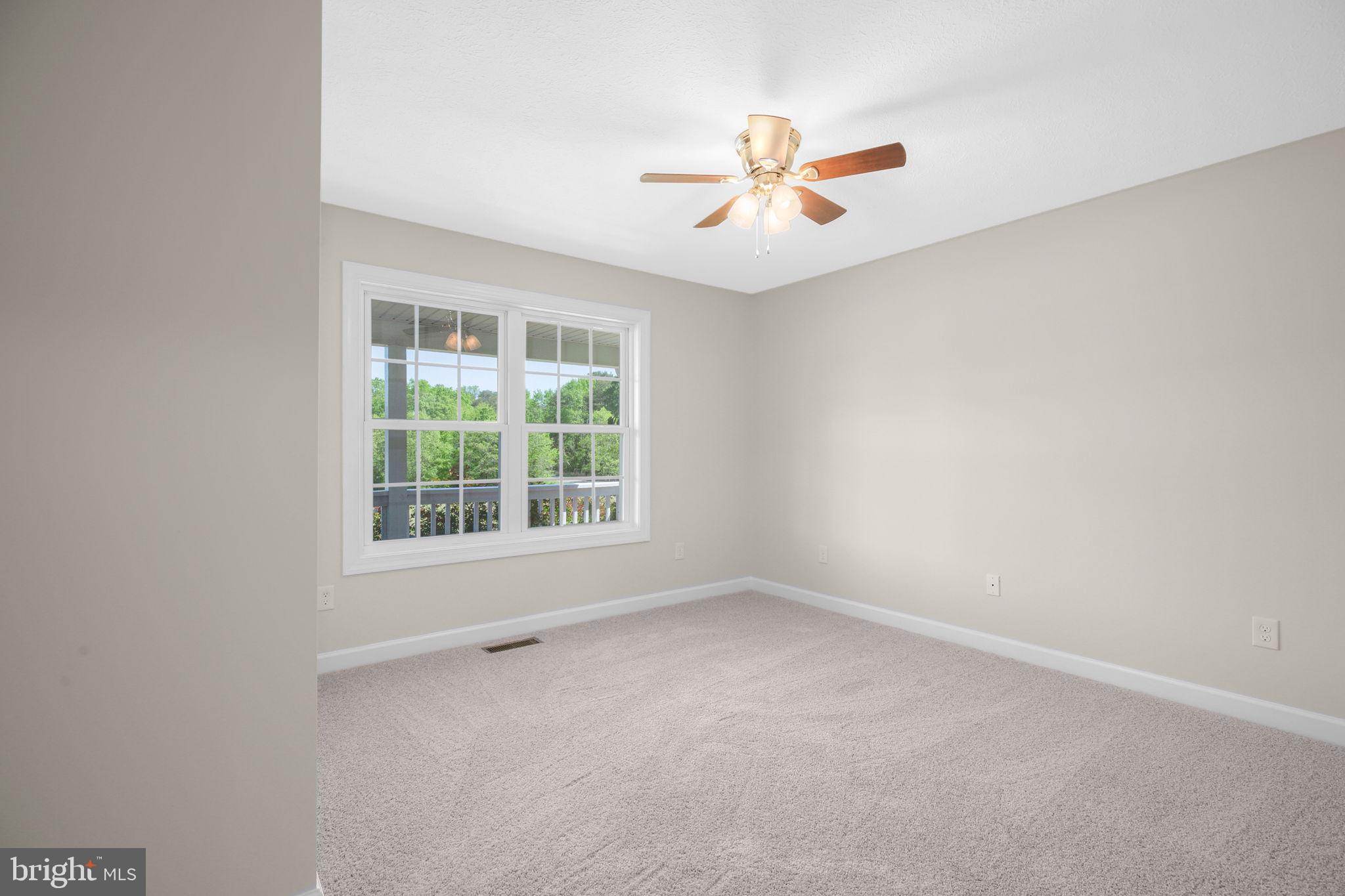 33 Austin Way Bumpass, VA 23024 - Photo 49 of 55 an empty room with a window and a fan