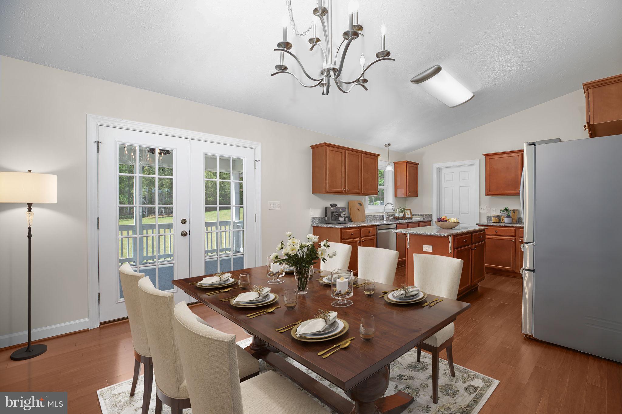 33 Austin Way Bumpass, VA 23024 - Photo 5 of 55 a view of a dining room with furniture a kitchen and chandelier