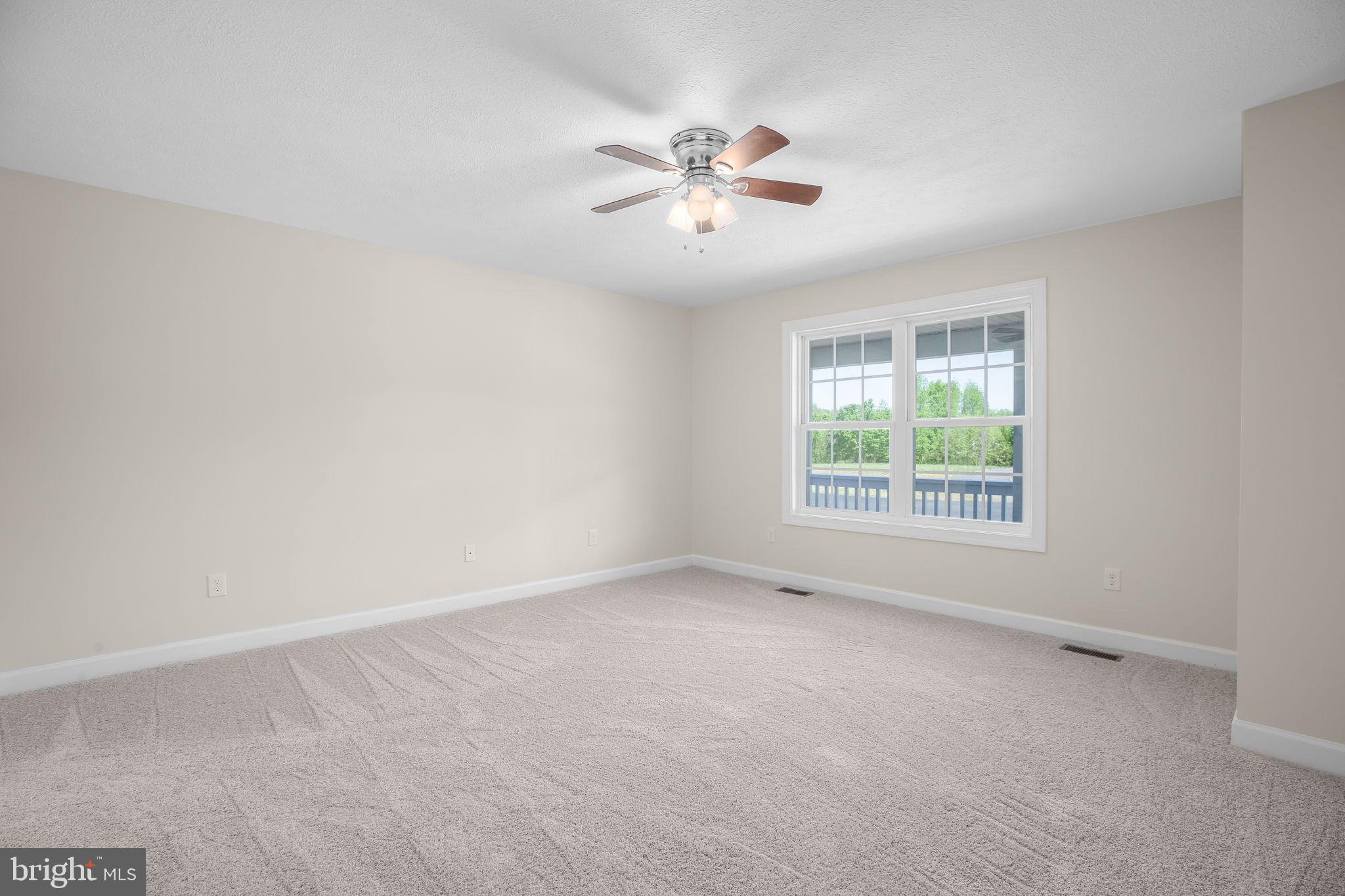 33 Austin Way Bumpass, VA 23024 - Photo 52 of 55 an empty room with a window and a fan