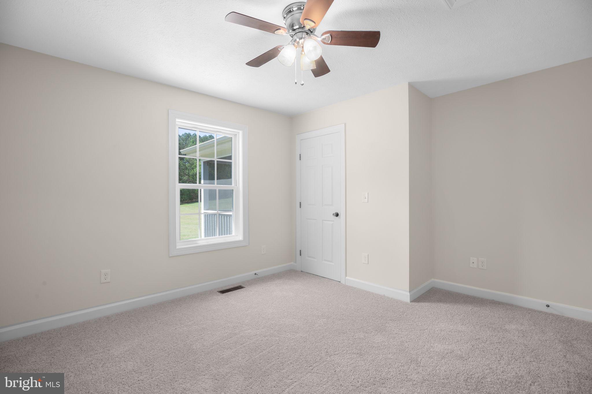 33 Austin Way Bumpass, VA 23024 - Photo 55 of 55 an empty room with windows and fan