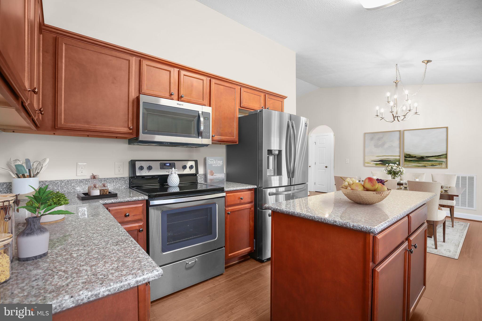 33 Austin Way Bumpass, VA 23024 - Photo 6 of 55 a kitchen with stainless steel appliances granite countertop a sink stove and refrigerator
