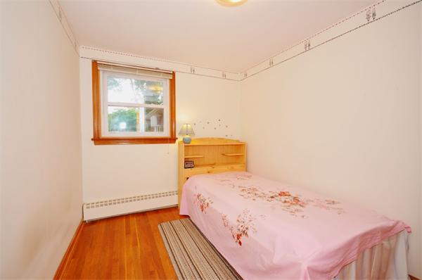 7 Senator Road Woburn, MA 01801 - Photo 12 of 26 a bedroom with a bed and wooden floor