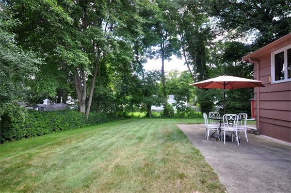 7 Senator Road Woburn, MA 01801 - Photo 20 of 26 a view of a backyard with a patio and garden